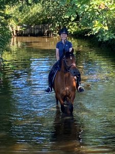 Riley and Sharon riding through a water feature