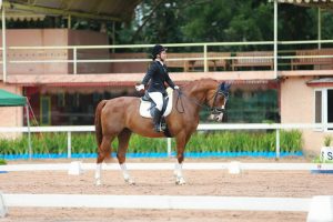 Patty, happy with her test on her first horse Antonio, at one of their first shows in Thailand in 2013